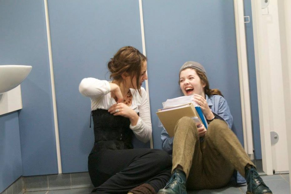 Clare and a friend laughing on the floor